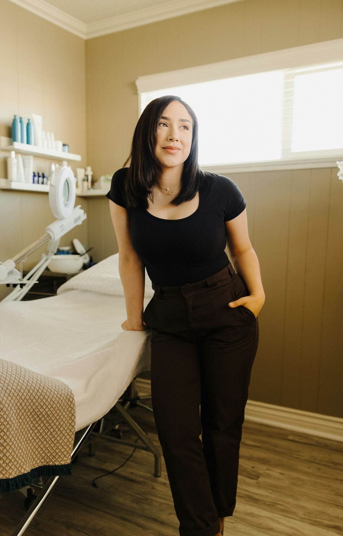 Beauty professional in a bright treatment studio