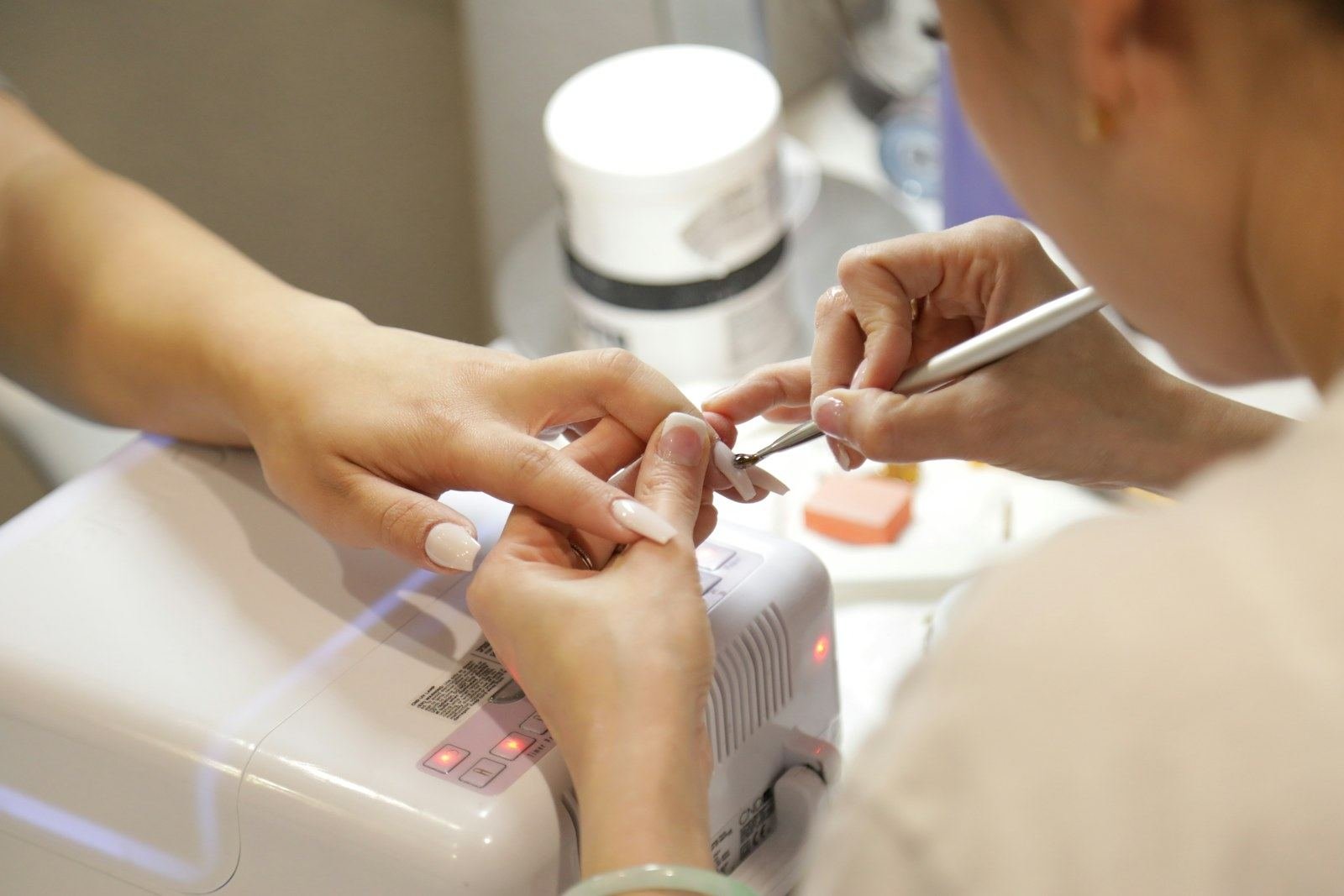 Nail professional completing a careful studio manicure