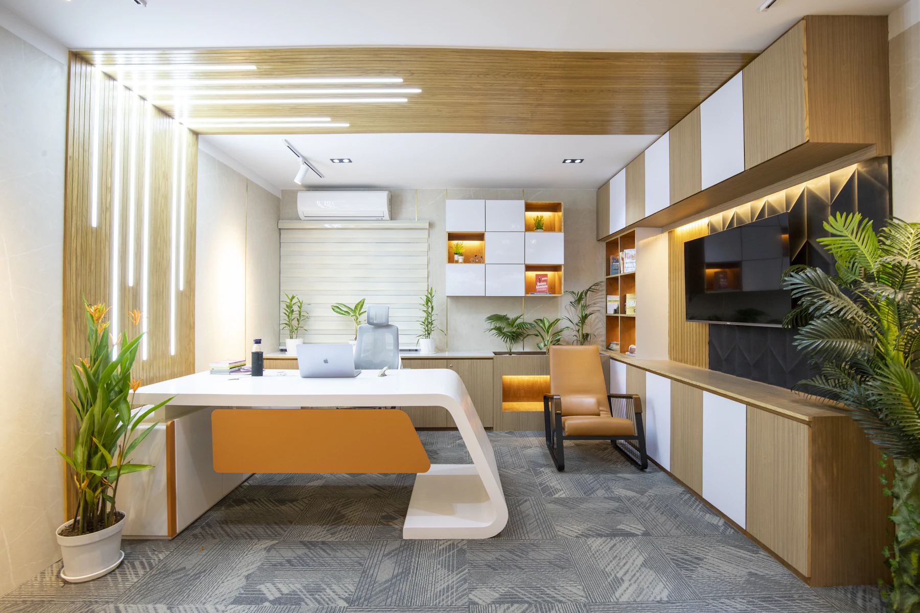 Completed quiet office with built-in desk and warm material finishes
