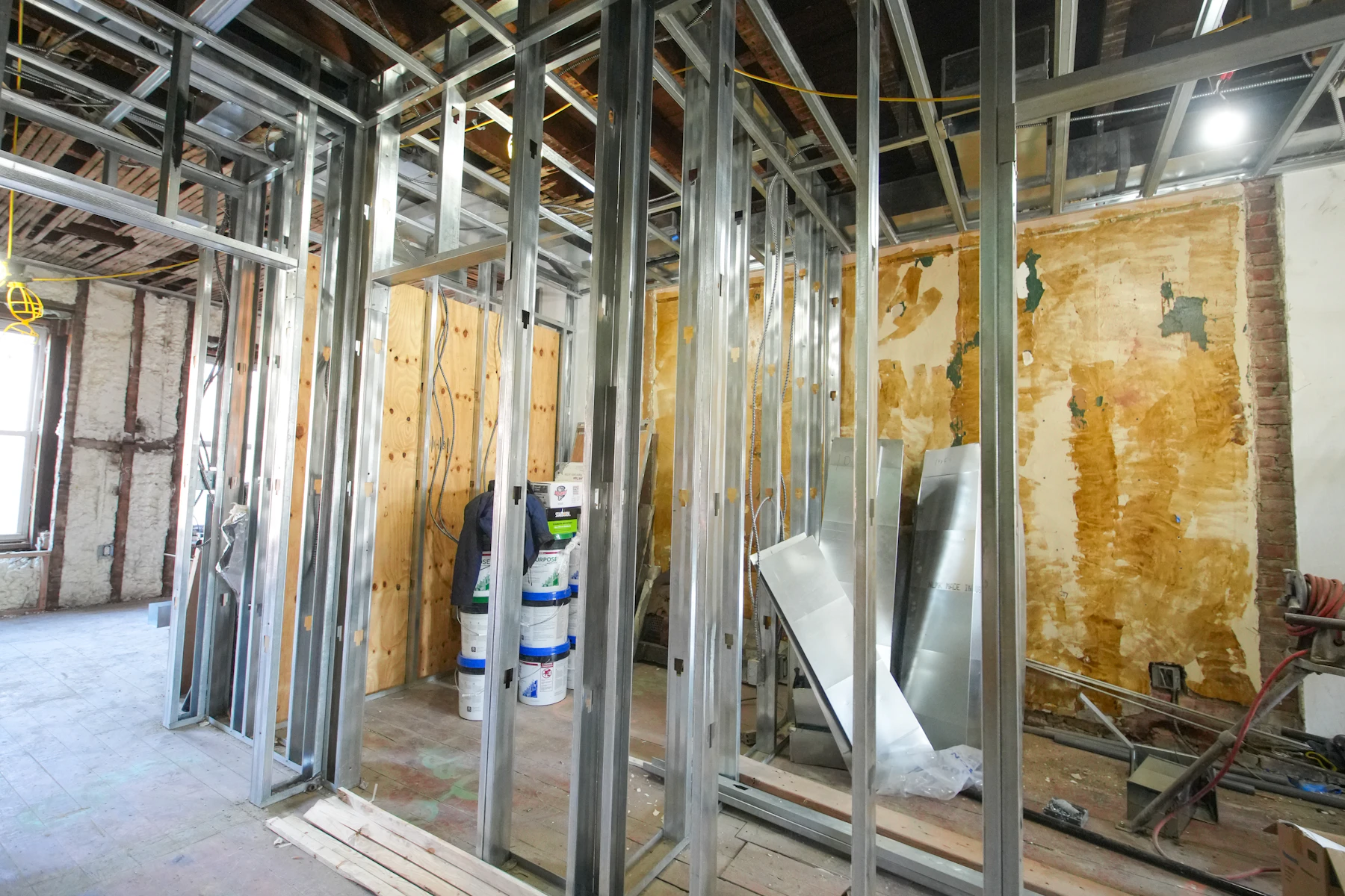 Metal framing and building-services routes visible during a commercial refurbishment