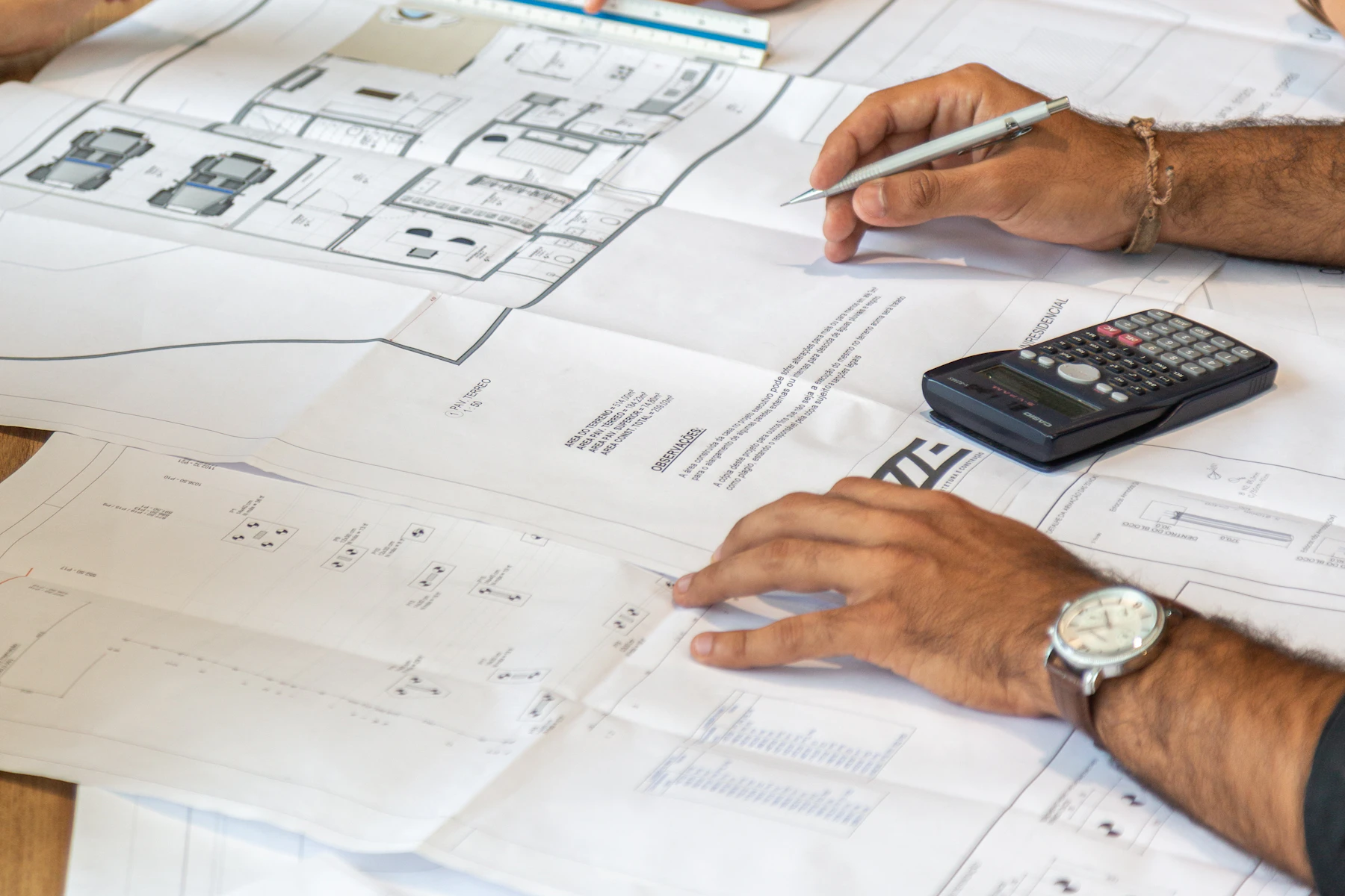 Project team reviewing architectural drawings around a shared table
